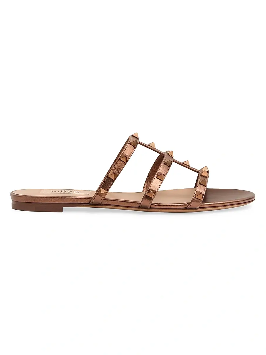 Valentino Garavani Women's Rockstud Flat Metallic Nappa Slide Sandals - Bronze | Image 1 Valentino Garavani Women's Rockstud Flat Metallic Nappa Slide Sandals - Bronze | Image 1