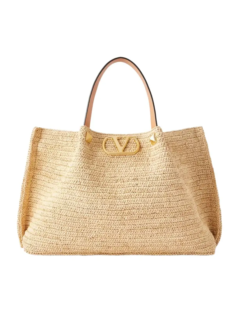 Valentino Garavani Vlogo Studded Leather-trimmed Woven Raffia Tote | Image 1 Valentino Garavani Vlogo Studded Leather-trimmed Woven Raffia Tote | Image 1