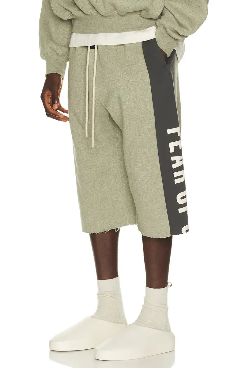 Fear of God ESSENTIALS Panelled Undone Cut Off Sweatpant | Image 1 Fear of God ESSENTIALS Panelled Undone Cut Off Sweatpant | Image 1