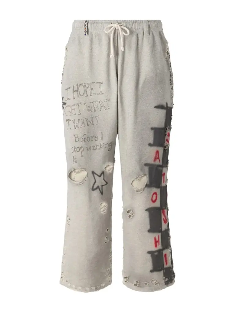 Satoshi Nakamoto Get What I Want Printed Embellished Distressed Cotton-Jersey Sweatpants - Men | Image 1 Satoshi Nakamoto Get What I Want Printed Embellished Distressed Cotton-Jersey Sweatpants - Men | Image 1