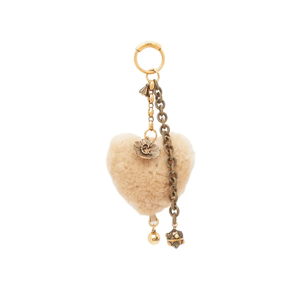 Chloé Chloé Symbols Heart Shearling bag charm in brass | Image 1 Chloé Chloé Symbols Heart Shearling bag charm in brass | Image 1